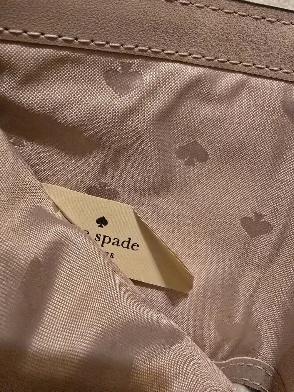 Kate Spade New York Staci small zip-around bifold wallet featuring a glittery ro